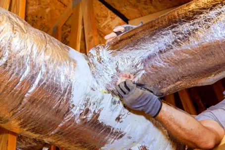 technician sealing leaky ductwork